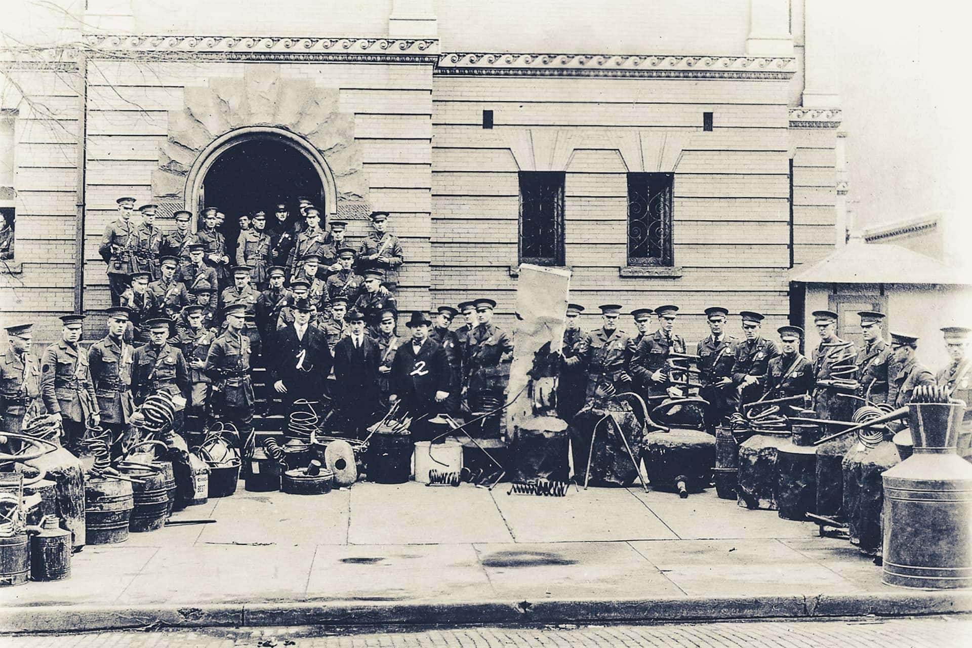 West Virginia State Police with a collection of confiscated stills at the old Mingo County courthouse.