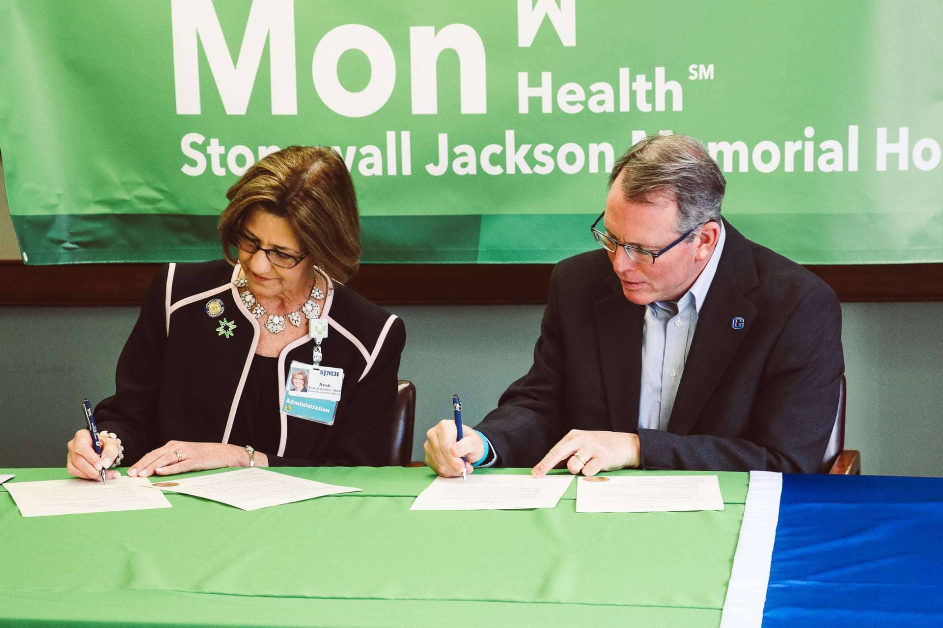 Stonewall Jackson Memorial Hospital CEO Avah Stalnaker, left, and Glenville State College President Dr. Tracy Pellett at the signing ceremony.