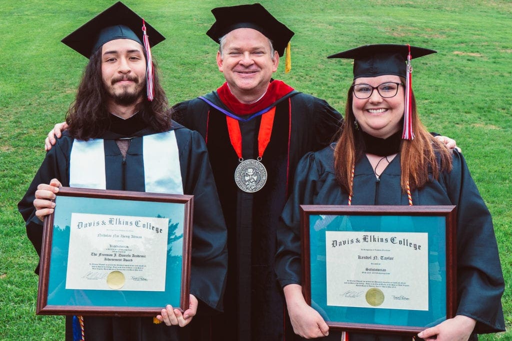 D&E President Chris A. Wood congratulates valedictorian Nick Altman and salutatorian Kendyl Taylor.