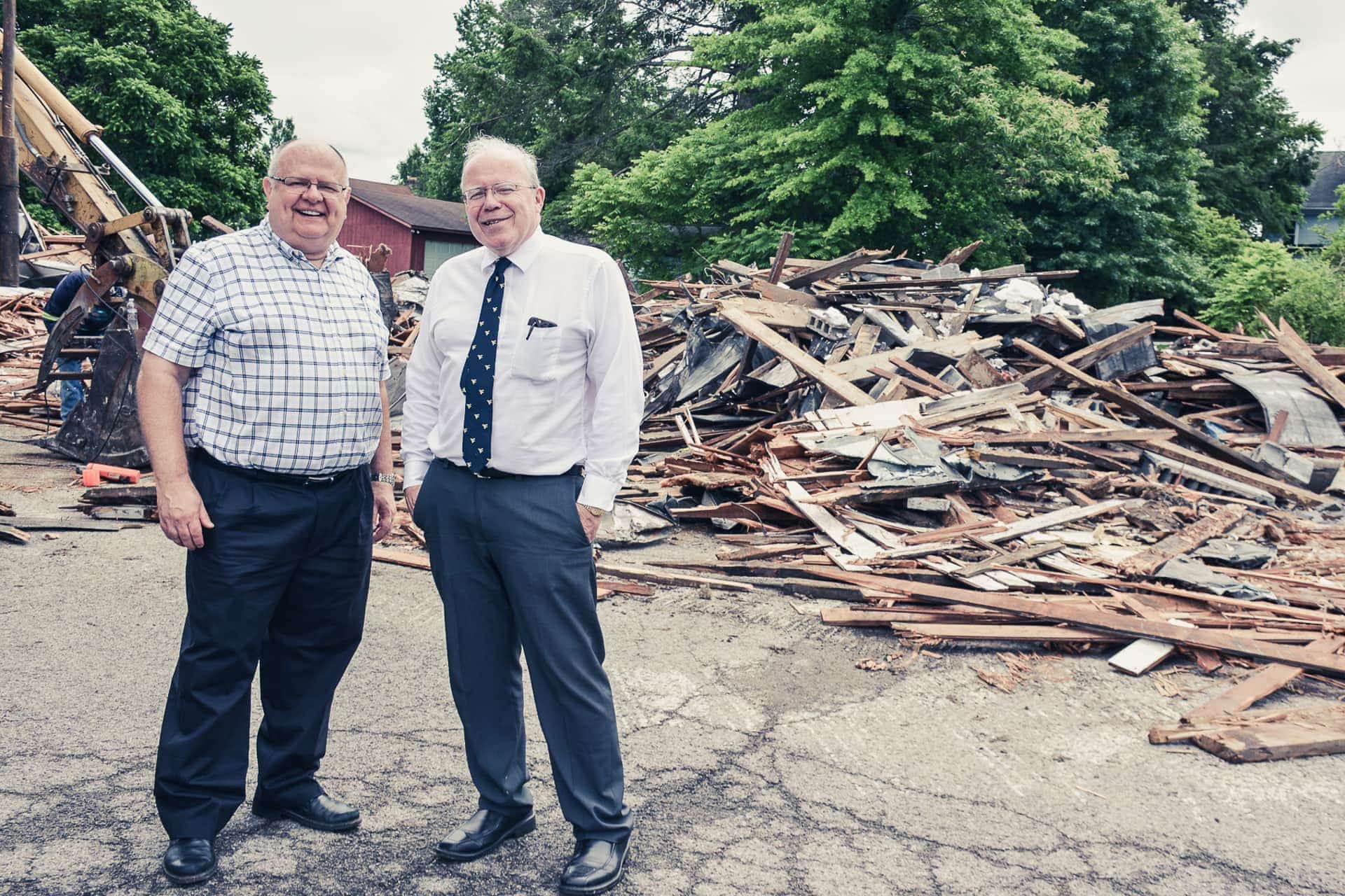 Recently-appointed city recorder Randy Sanders, left, and mayor David McCauley check out the work at the Upshur County Board of Education office Tuesday. The city and school system combined forces to tear down an abandoned storage facility to make room for additional parking.