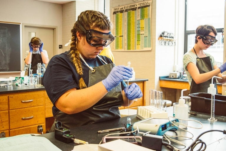 Jordan Means transfers a known concentration of blue #1 food dye into a colorimeter vial to measure absorbance.