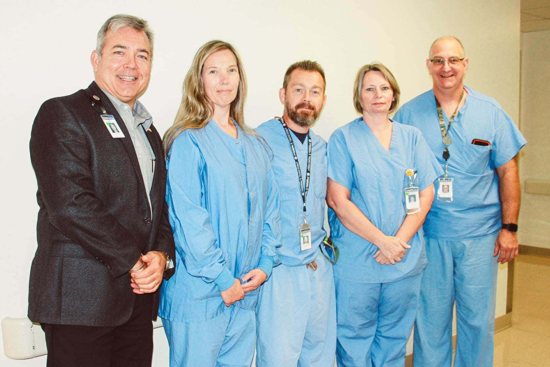 Pictured, left to right: Skip Gjolberg, President; Surgical Technologists: Sue Tenney, Robert Goodwin, and Beatrice Mayle; Kevin Stingo, Manager, Perioperative Services