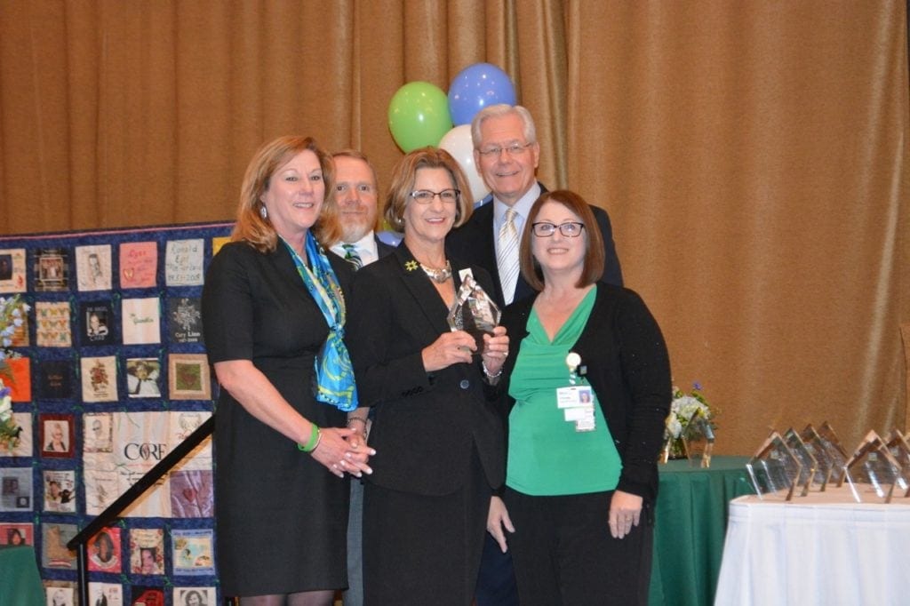 Pictured are Mon Health Stonewall Jackson Memorial Hospital CEO Avah Stalnaker and SJMH employee Christa Shaver along with members of the CORE staff including CORE CEO Susan Stuart and CORE WV Professional Services Liaison, Jeremy Zeiders, and president of the WV Hospital Association, Joe Letnaunchyn, during the annual CORE luncheon at Stonewall Resort.