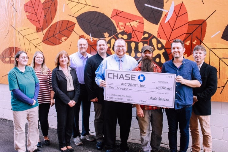 Kyle Wilson of Chase Bank (center) presents the donation to ART26201 members Allison Corbin, Virginia Hicks, Lisa Wharton, C.J. Rylands, and John Waltz, on left, and Tim Hibbs, Bobby Howsare, and Bryson VanNostrand on right.