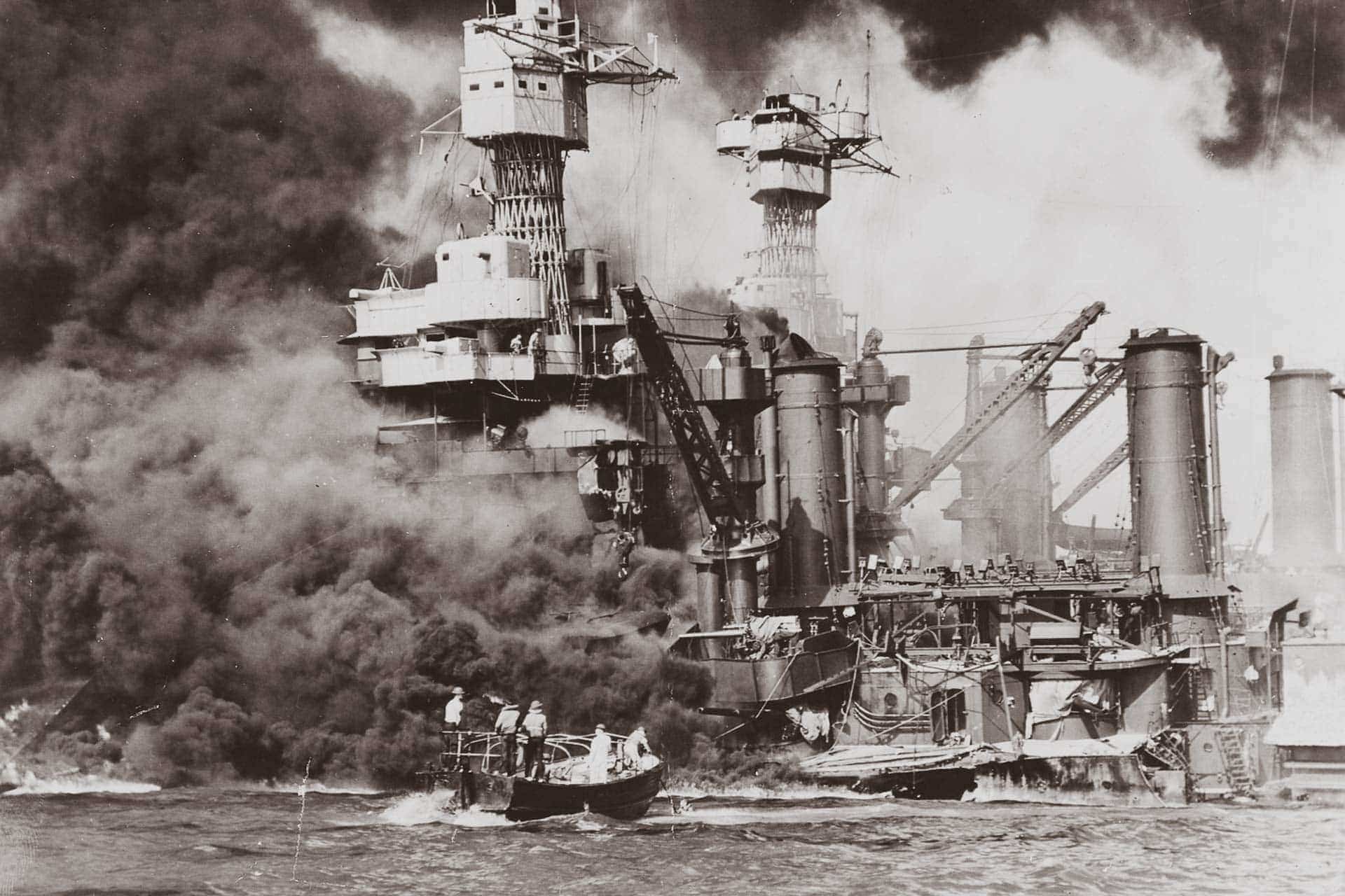 A small boat rescues a seaman from the 31,800 ton USS West Virginia after the attack on Pearl Harbor, December 7, 1941.
