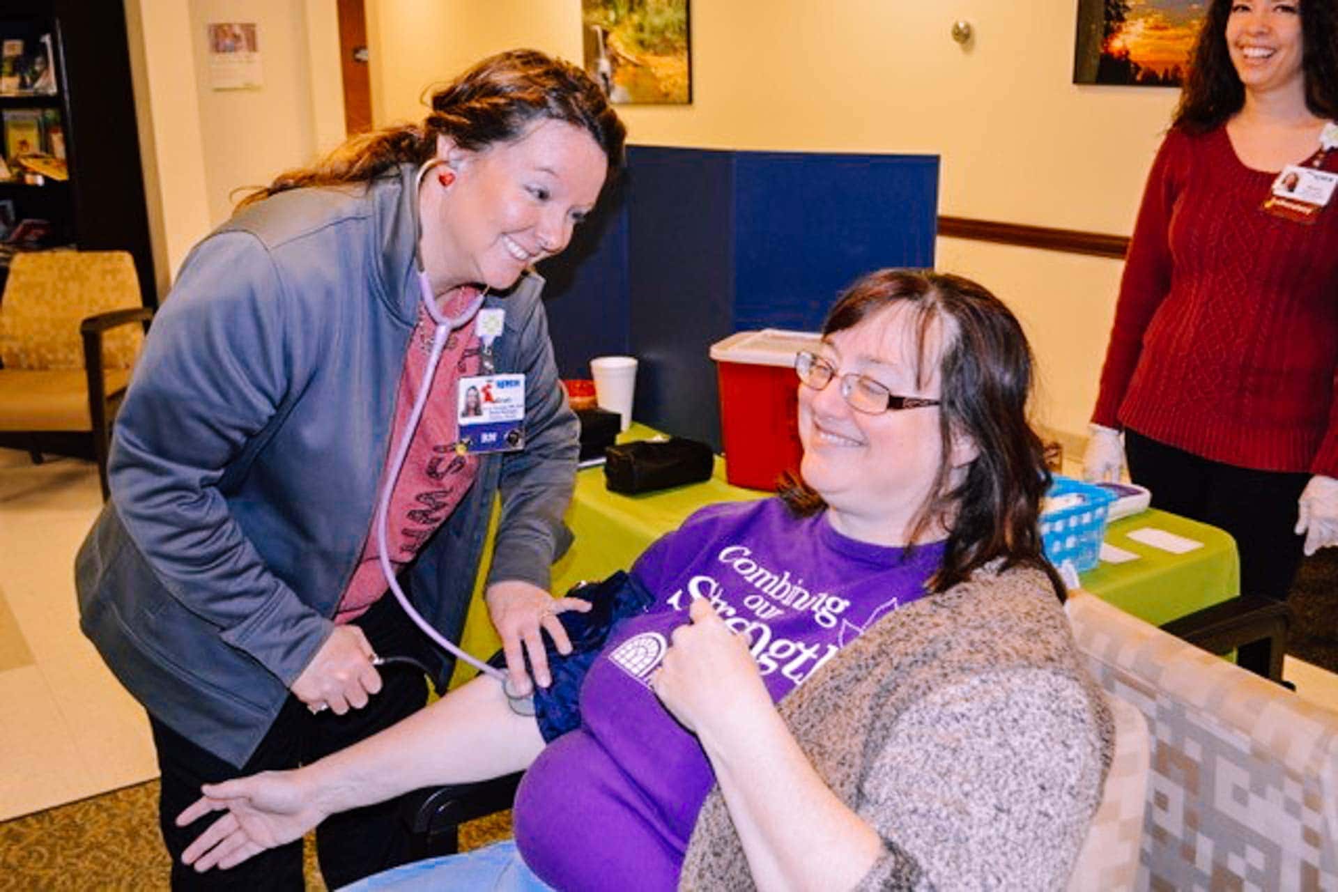 Cardiac Rehabilitation staff member Kristi Gannon takes the blood pressure of a patient Edie Withers at last year’s Healthy Heart Fair held at Mon Health Stonewall Jackson Memorial Hospital.