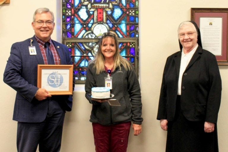 Skip Gjolberg, President of St. Joseph’s Hospital, and Sister Francesca Lowis, Vice President of Mission Integration, present the VIP Award to Becky Pullen.
