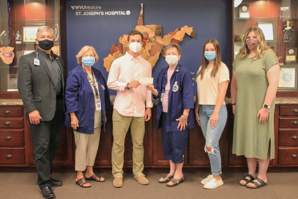 Left to right: Skip Gjolberg, President of St. Joseph’s Hospital; Patty McComas, Auxiliary President; Samuel Walker, Vonnie Hager, Auxiliary Scholarship Chair; Brianna Burnette, and Sydney Maxwell.