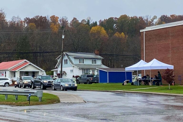 Cars form a line for COVID-19 testing at Buckhannon-Upshur Middle School on Sunday.