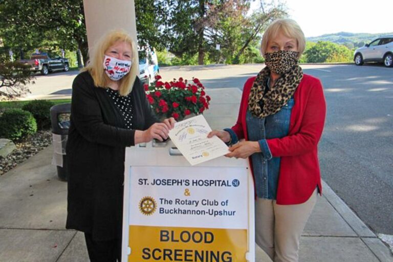 Julie Keehner, left, presents the Rotary Certificate of Membership to Susan Aloi.