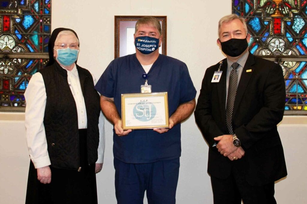 Left to Right: Sister Francesca Lowis, Vice President of Mission Integration; Brad Ling, RN; and Skip Gjolberg, President, St. Joseph’s Hospital