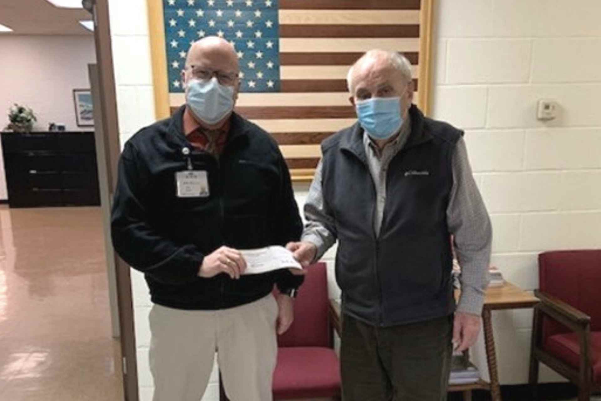 Foundation Director Mike Bell (left) accepts a generous donation from Mike Ross (right) for Davis Medical Center’s Laurel Place geropsychiatric unit.