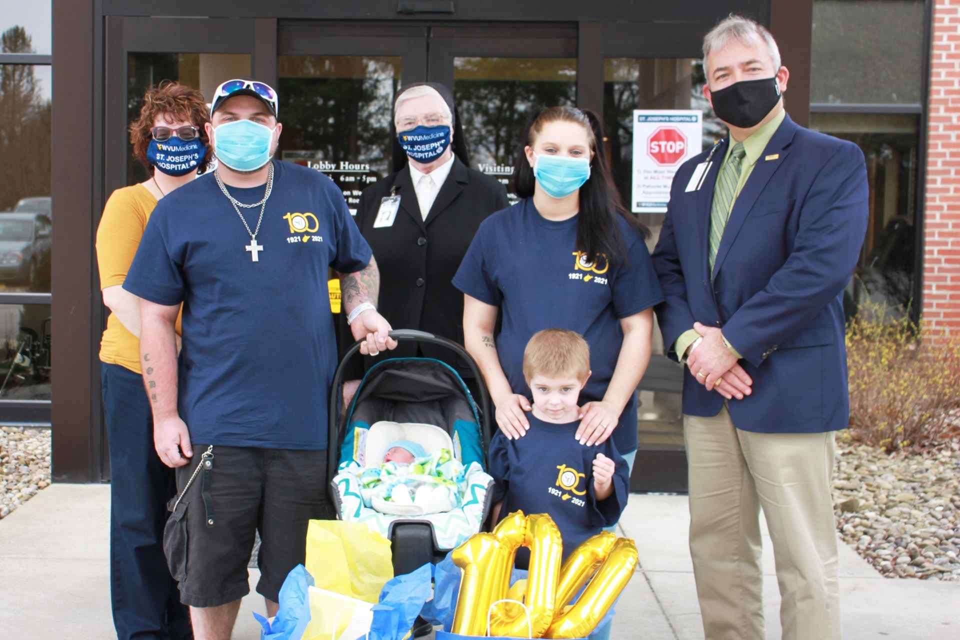 Left to right: Kathy White, Medical Staff Coordinator; Cody Merriman; Sister Francesca Lowis, Vice President of Mission Integration; Kristan Green; Skip Gjolberg, President; and new baby and son.