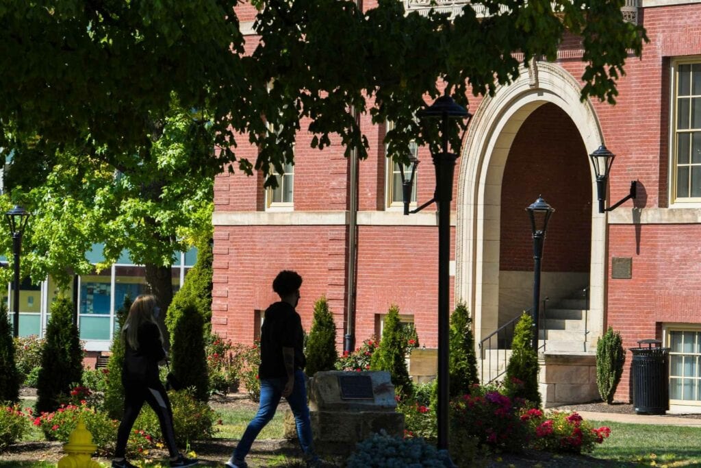 Pedestrians walk through Woodburn Circle past Chitwood Hall on the downtown campus Monday, Sept. 21, 2020. (WVU Photo/Jennifer Shephard)
