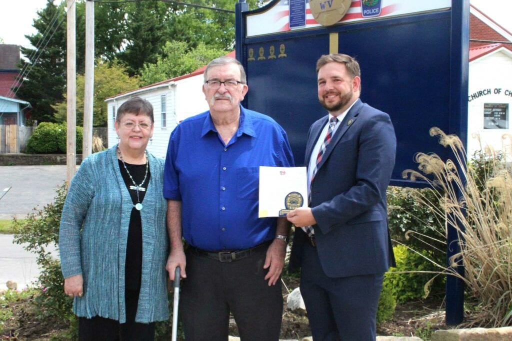 Mayor Robbie Skinner, right, honors Darrell Bennett, who is joined by his wife, Patty.