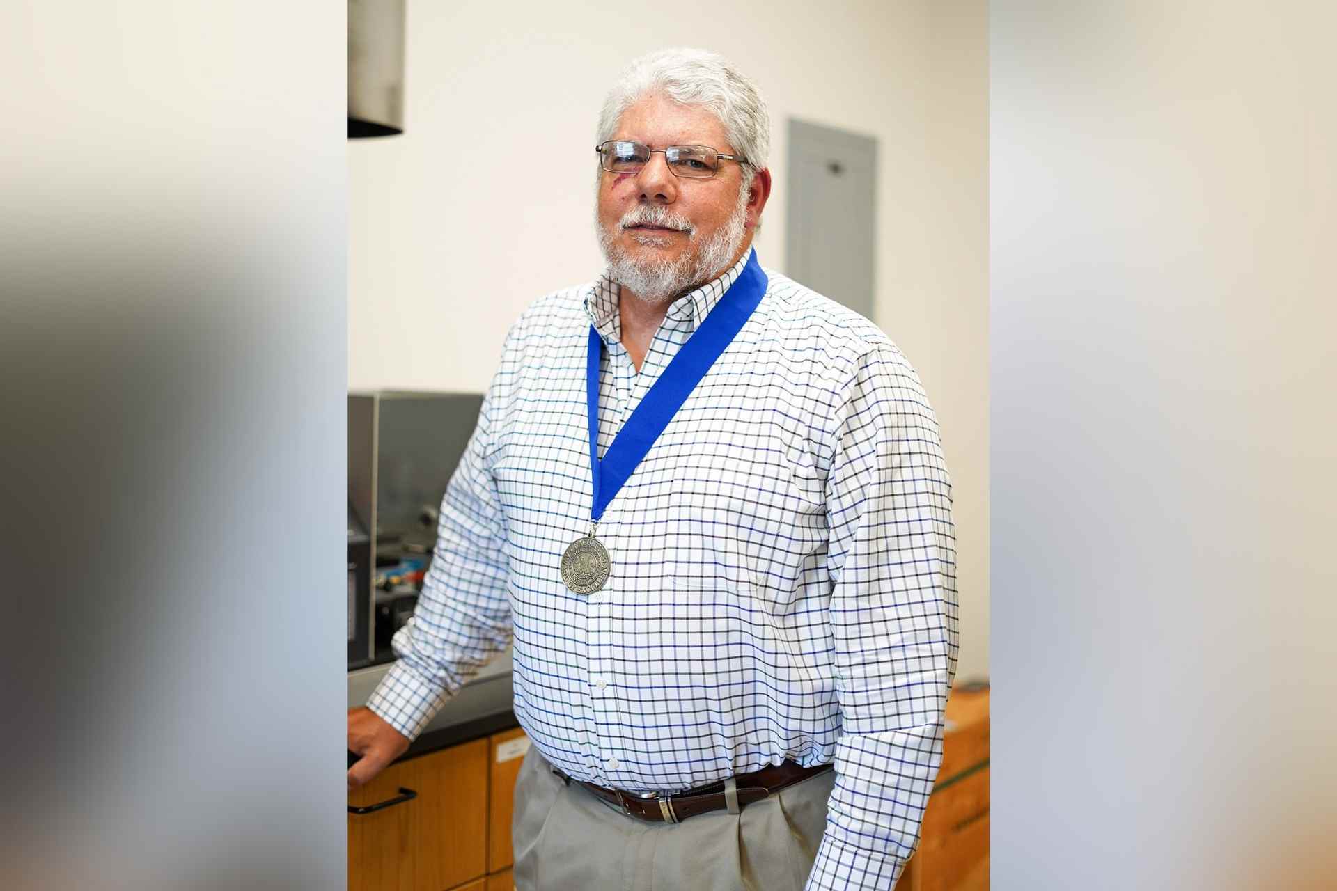 Glenville State College Professor of Chemistry Dr. David O’Dell, pictured wearing his 2021 Faculty Award of Excellence medallion.