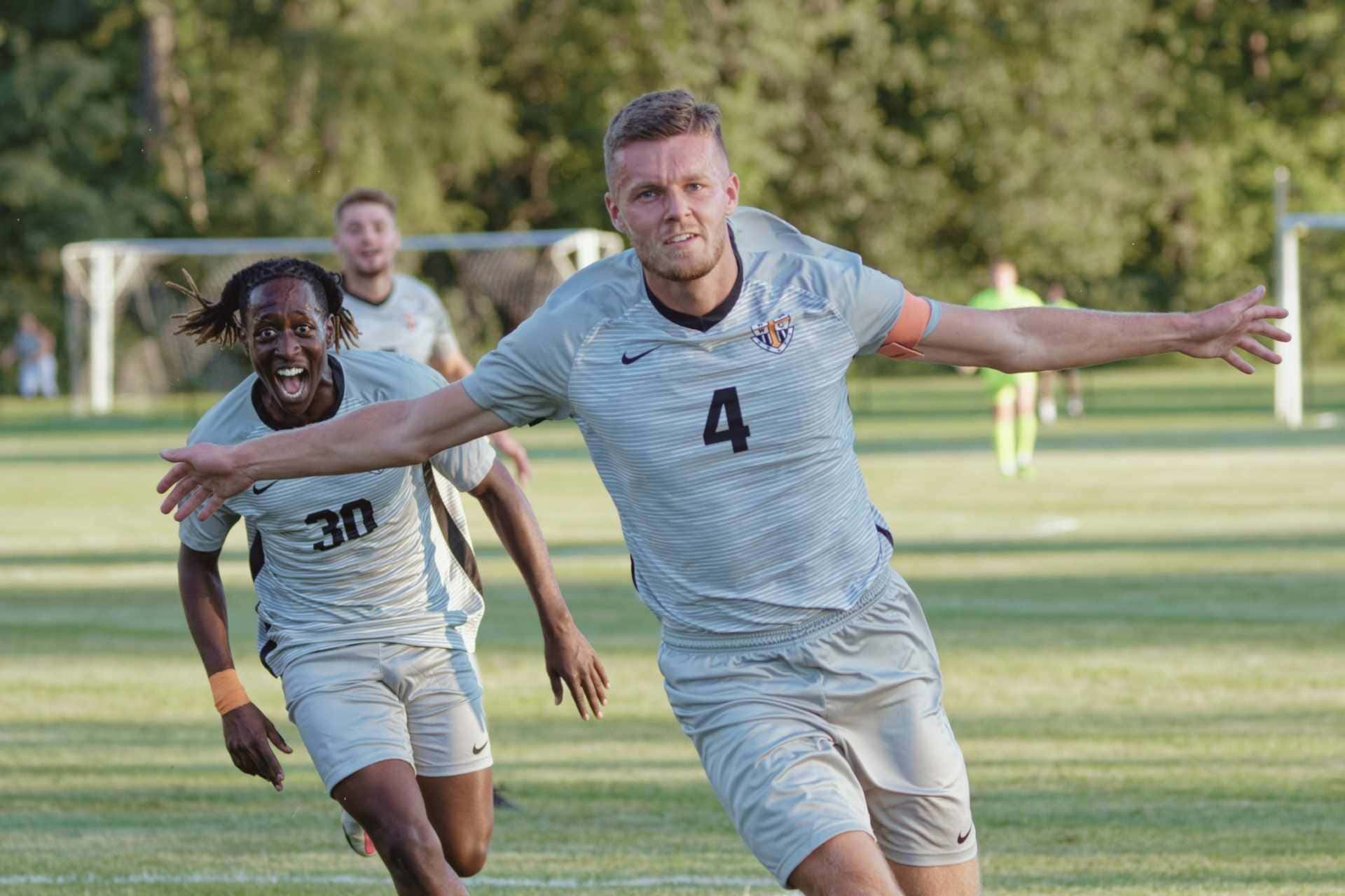 Connor Hartwell (4) celebrates after scoring on a free kick in Thursday's season opener against Cal. Also pictured is Chris Irakoze (30).