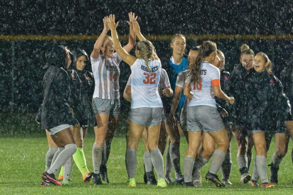 Wesleyan's Morgan Mitchell (32) congratulates Danielle Jonas (14), who had the golden goal as the Lady 'Cats beat Fairmont State 1-0 in overtime.