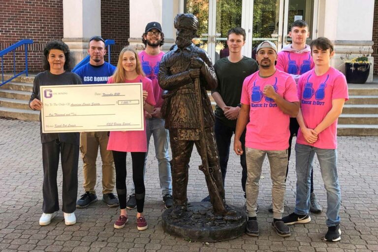 American Cancer Society representative Charla Barrett (left) holds a $1,000 check presented to the American Cancer Society from the members of the Glenville State College Boxing Team. The money donated was raised as part of their “Knock Out Cancer” fundraiser.