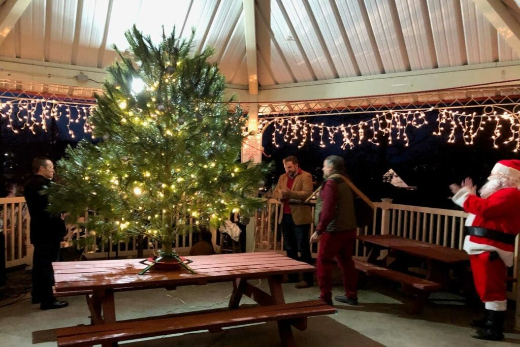 Hundreds of families gather at the Buckhannon Park Thursday to celebrate an ‘Old Fashioned Christmas.’ Buckhannon Mayor Robert N. Skinner flips the switch to light the Christmas Tree donated by French Creek Christmas Trees as Santa Claus looks on. Activities in the park included a live nativity scene, live music, visits with Santa Claus and free cookies, hot chocolate, masks, coloring books and stockings for youngsters. This is the first year for the event, but organizers said they hope to make this a yearly tradition in Buckhannon.