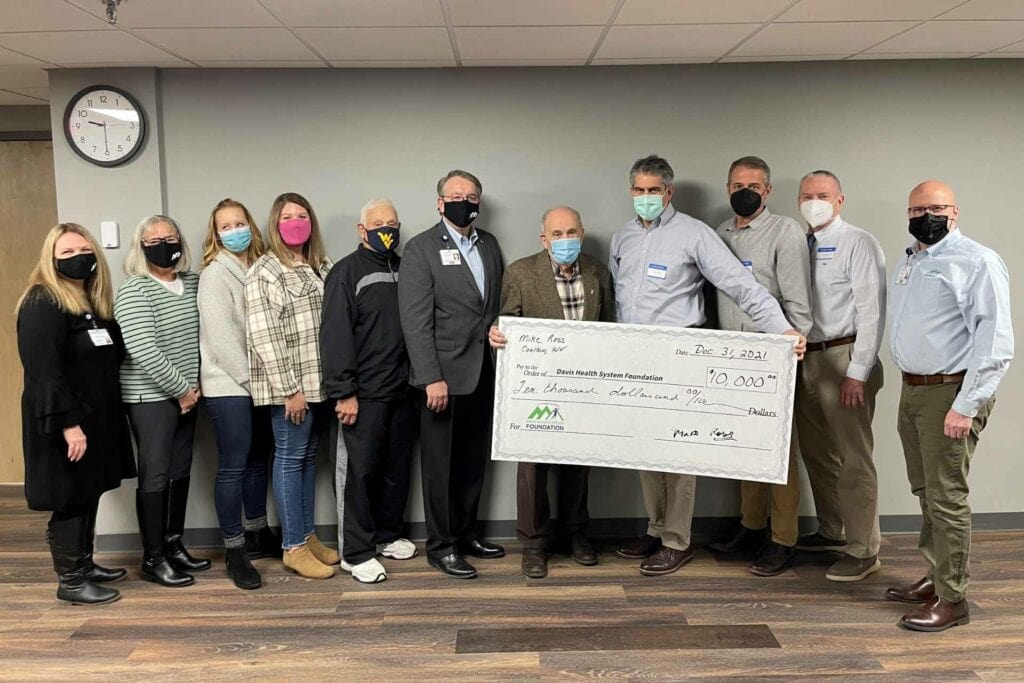 Pictured, left to right: Jennie Raines, DHS Foundation Community Giving Specialist; Diana Vannoy, Foundation Board Member; Dr. Misha Phillips-Lee, Foundation Board Member; Whitney Morris, Foundation Board Member; Sterl Dean, Foundation Board Member; Vance Jackson, Davis Health System President & CEO; Mike Ross; Mike Cvechko, Foundation President; Jeff Zurbuch, Foundation Board Member; Hugh Hitchcock, Foundation Board Member; and Mike Bell, DHS Foundation Executive Director.