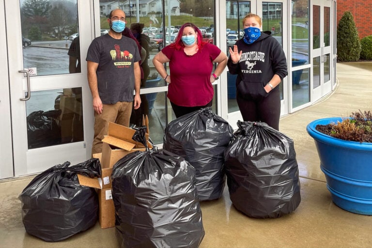 Glenville State University Environmental Science Club advisor Dr. Nabil Nasseri (left) and club members Jessica Green (center) and Veronica Rowse (right) with several bags of recyclable items collected from the Waco Center.