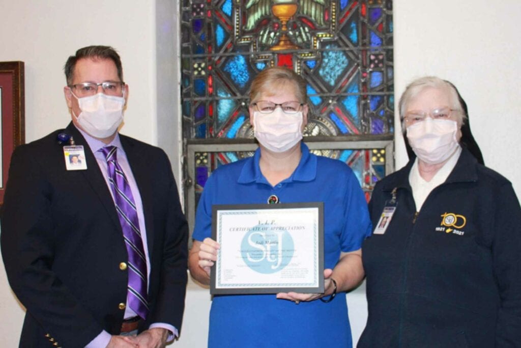 Rodney Baker, Vice President of Ancillary Services & Physician Practice Administrator, and Sister Francesca Lowis, Vice President of Mission Integration, present Jodi Martin with the VIP Award.