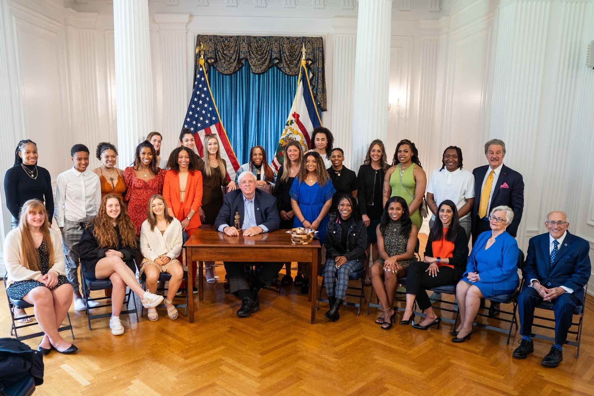 Members of the Glenville State University Lady Pioneers 2022 NCAA Division II Women’s Basketball National Champion team with West Virginia Governor Jim Justice, Glenville State University President Dr. Mark A. Manchin, and longtime Glenville State supporters Ike and Sue Morris. | Photo courtesy WV Governor’s Office