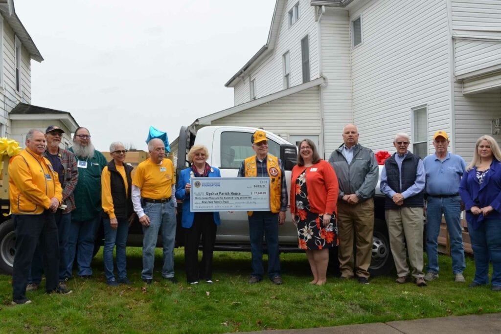 Lions Club District Governor Susan Long presents a check to Upshur Parish House Executive Director Kristi Wilkerson Tuesday to pay for a flatbed truck to pick up food from the Mountaineer Food Bank to distribute to neighbors in need. Each month the Upshur Parish House gets 6,000 to 10,000 pounds of food which it distributes to between 75 and 100 families per week in Upshur County who are facing food insecurities. Local Lions Club and the Buckhannon-Upshur Rotary Club partnered with Lions Club International Foundation for this venture.