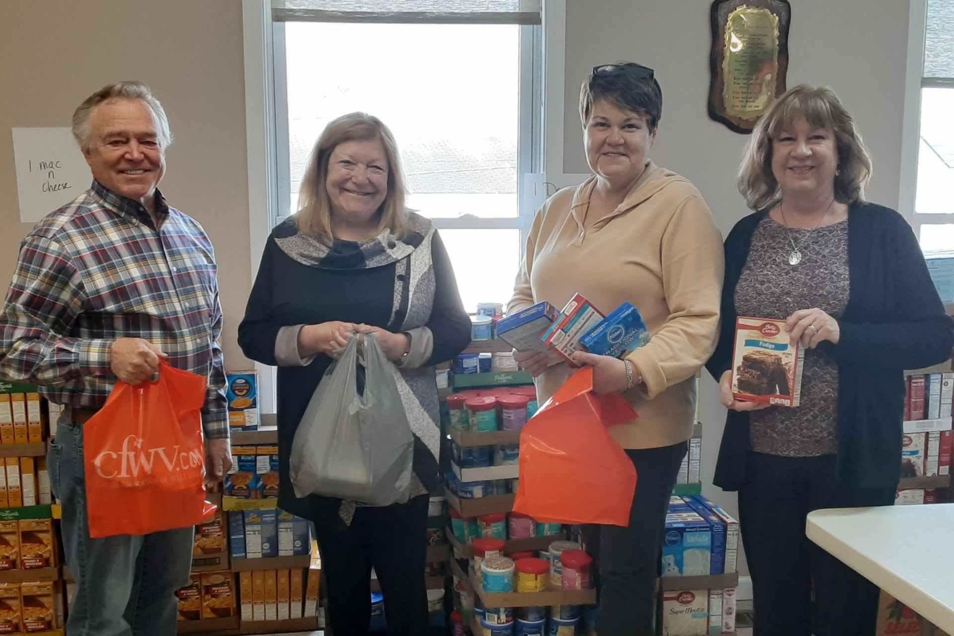 Rotarians Keith Buchanan, Julie Keehner, Kelley Tierney and Lisa Wharton volunteered their time to help pack Easter dinner boxes.