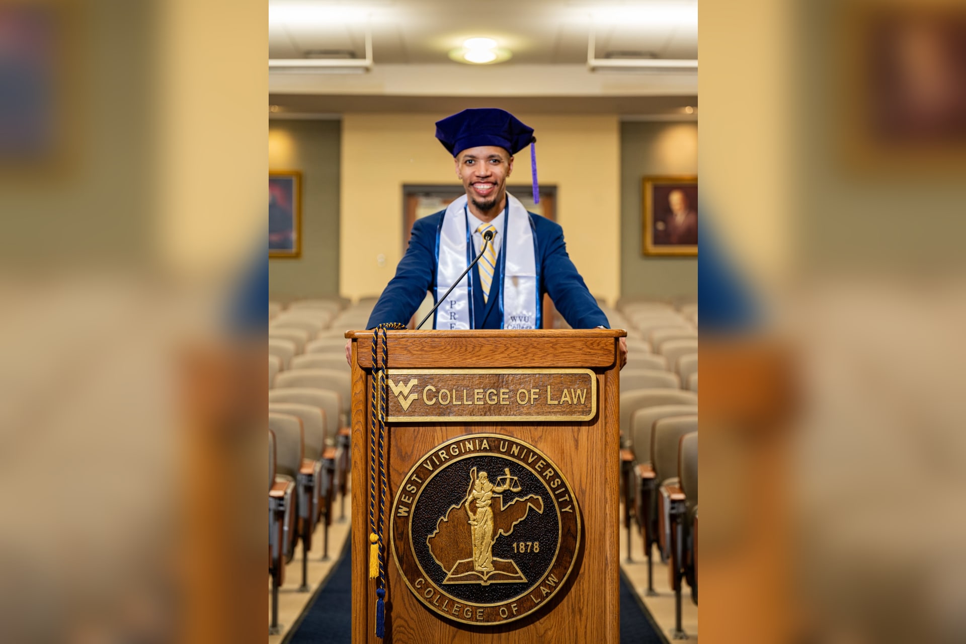 Chris Payne stands at a podium inside the WVU College of Law, where he has served as president of the WVU Law Class of 2026.