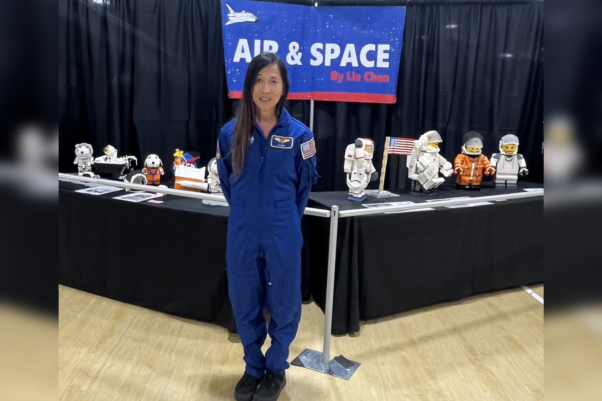 Lia Chan stands in front of her Air and Space By Lia Chan display of LEGO astronaut figures