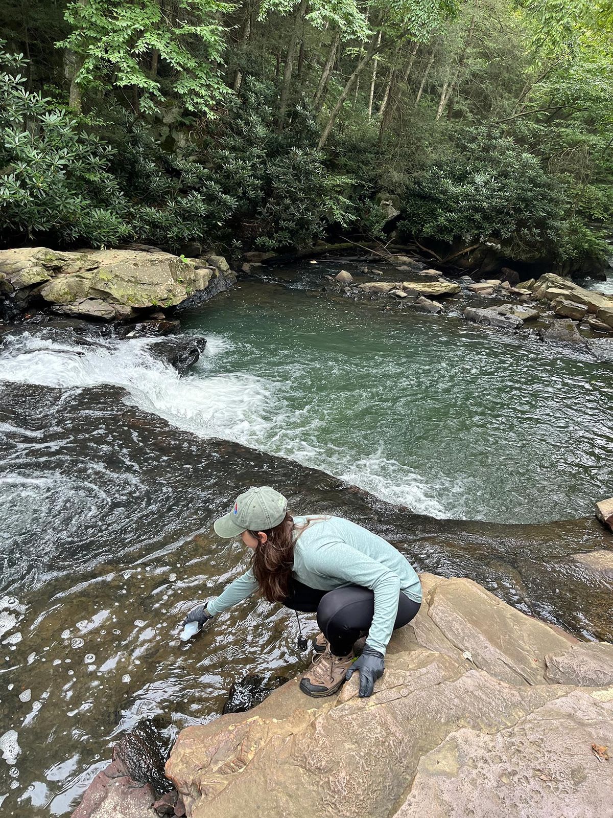 Sarah Nelson conducts bacteriological sampling in a creek. (Photo supplied by Sarah Nelson)