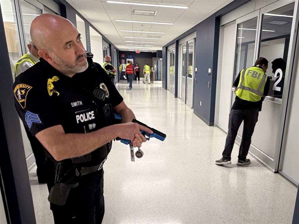 A WVU Police officer and an FBI representative search rooms during a simulated active-shooter exercise at the WVU Medicine Center for Nursing Education.