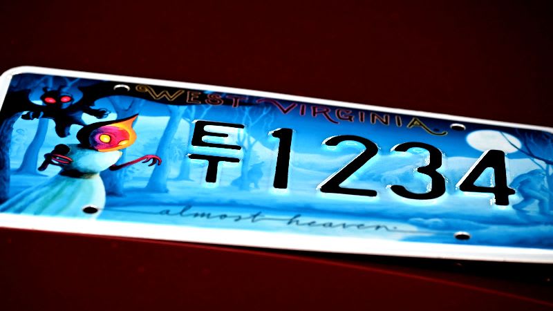 A sample West Virginia cryptids license plate displays its registration characters.