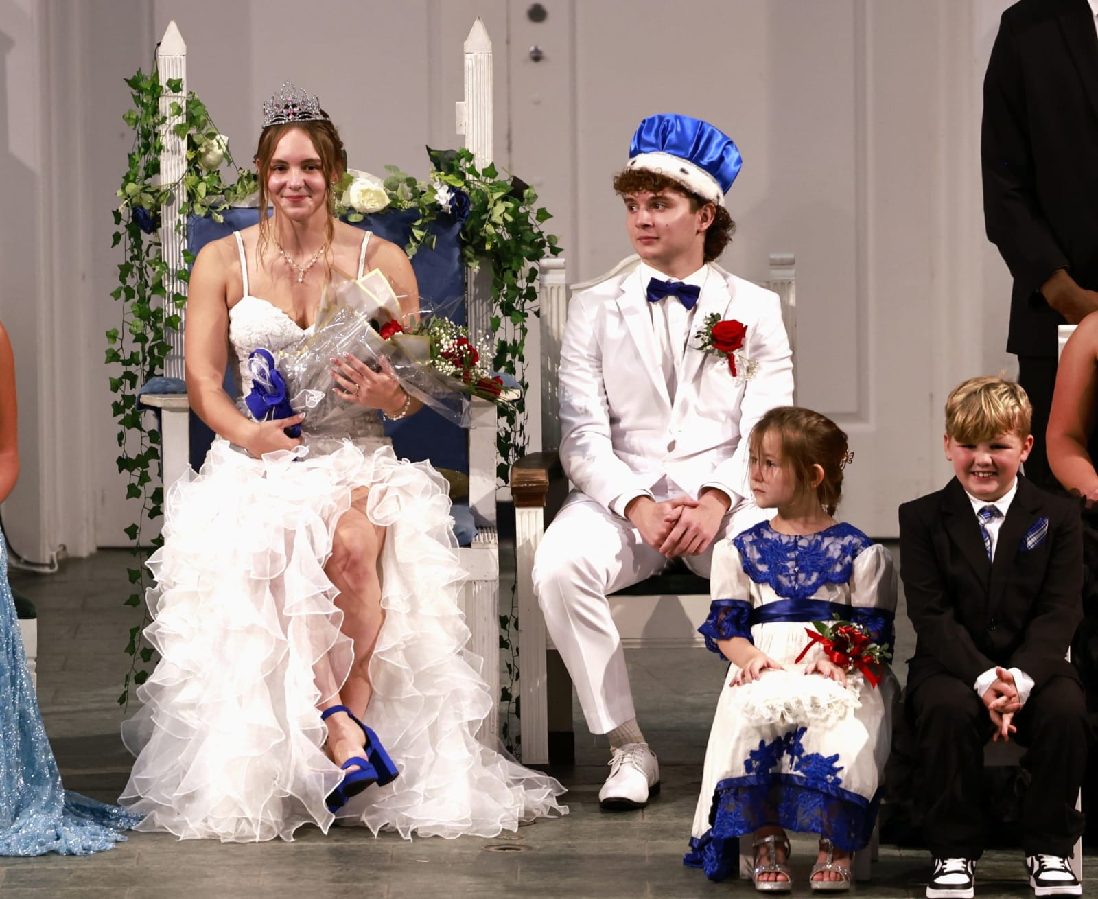 B-UHS homecoming royalty sit with the flower girl and crown bearer during coronation.